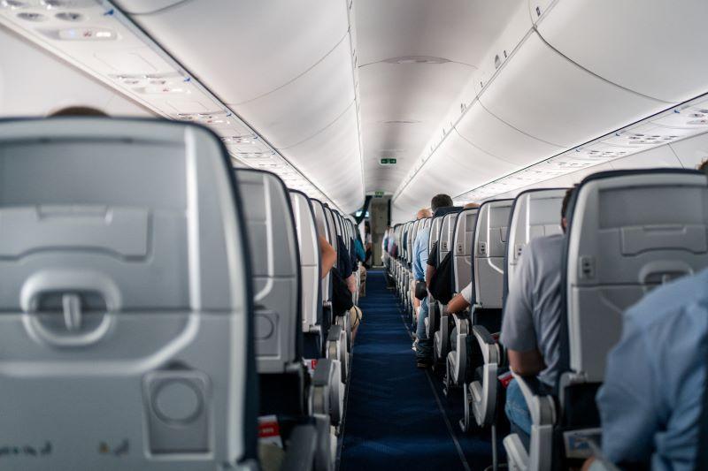 passengers sitting in airplane cabin