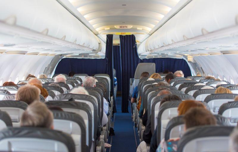 passengers sitting in the cabin of an airplane