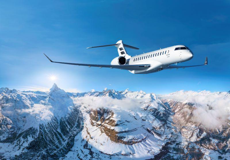 Bombardier 8000 flying over snowy mountains