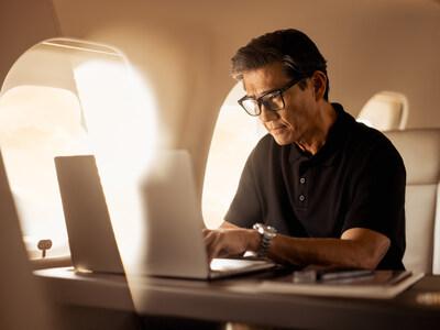 a man at a laptop using Wi-Fi on a Vista aircraft