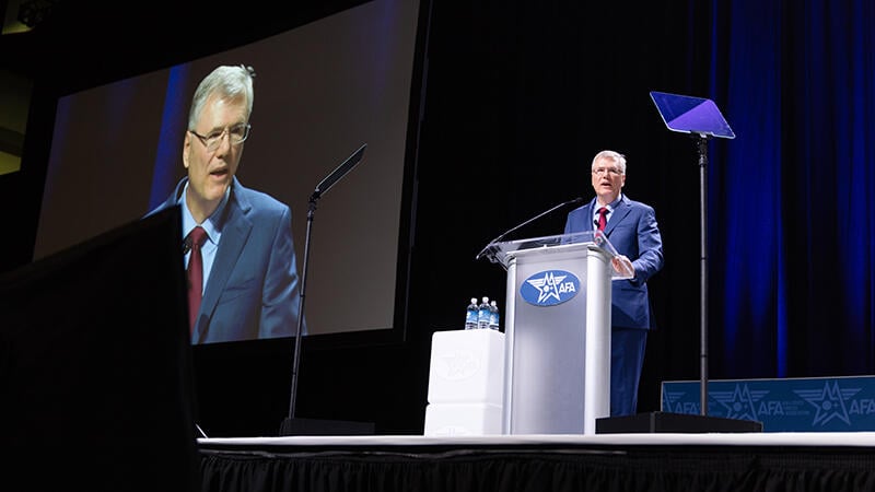 Troy Meink speaking at a lectern