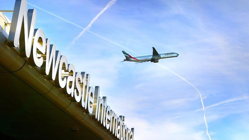 newcastle airport with emirates aircraft above