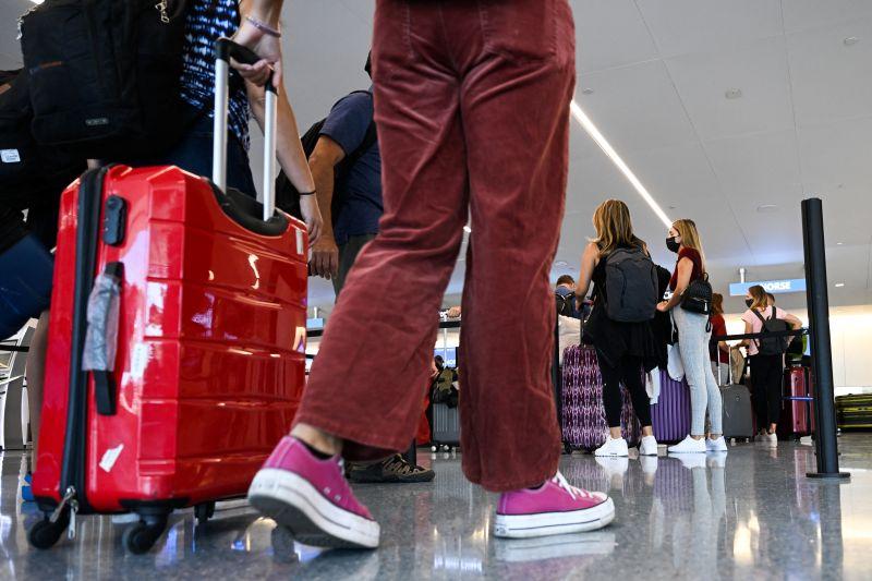 passengers and a red suitcase