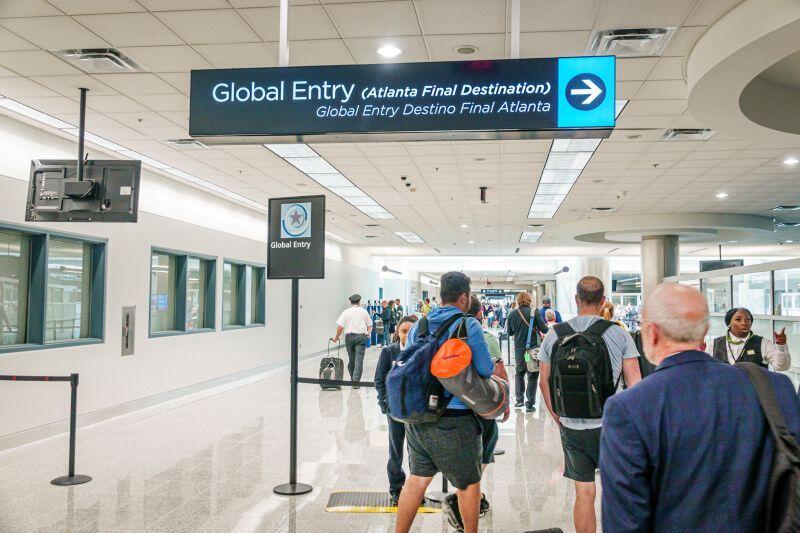 Global entry sign with travelers at Hartsfield-Jackson Atlanta Airport