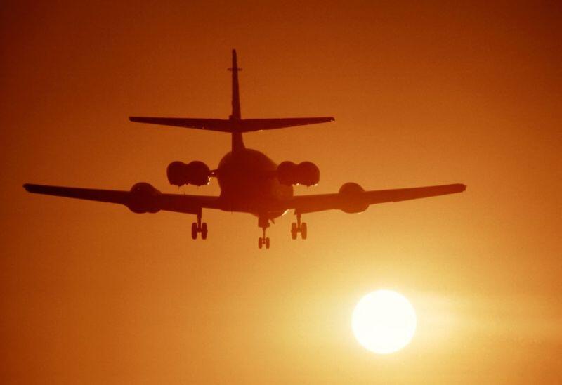 business jet inflight and a sunset