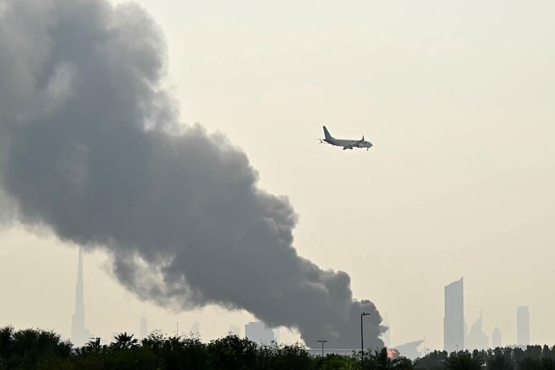 emirates jet flying over dubai airport