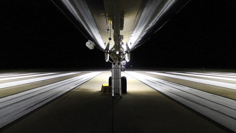 lit view underneath aircraft on runway