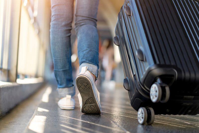 Traveler walking with a suitcase at an airport
