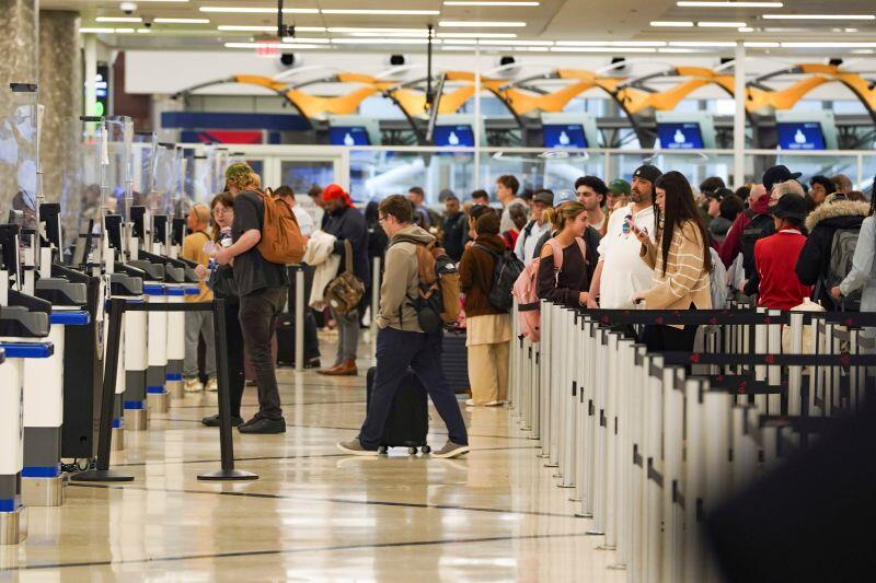 Travelers wait in long lines while only a few TSA check points are open at Hartsfield-Jackson Atlanta International Airport on March 16, 2026.