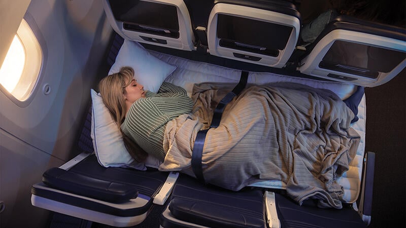 person sleeping on row of three seats