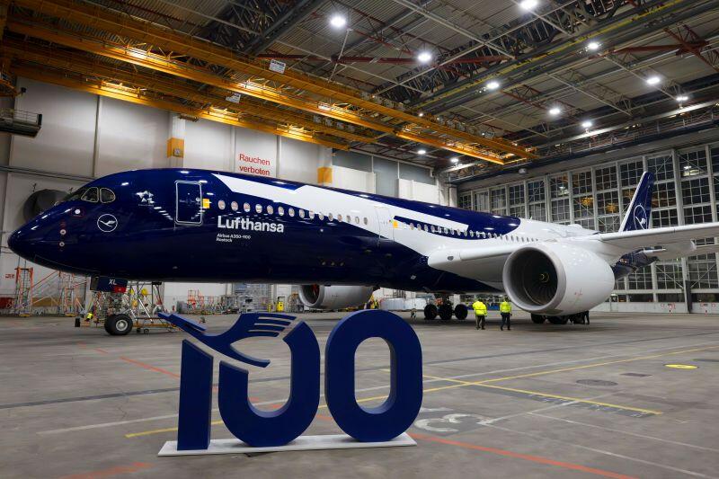 Lufthansa aircraft with 100 sign in front of it