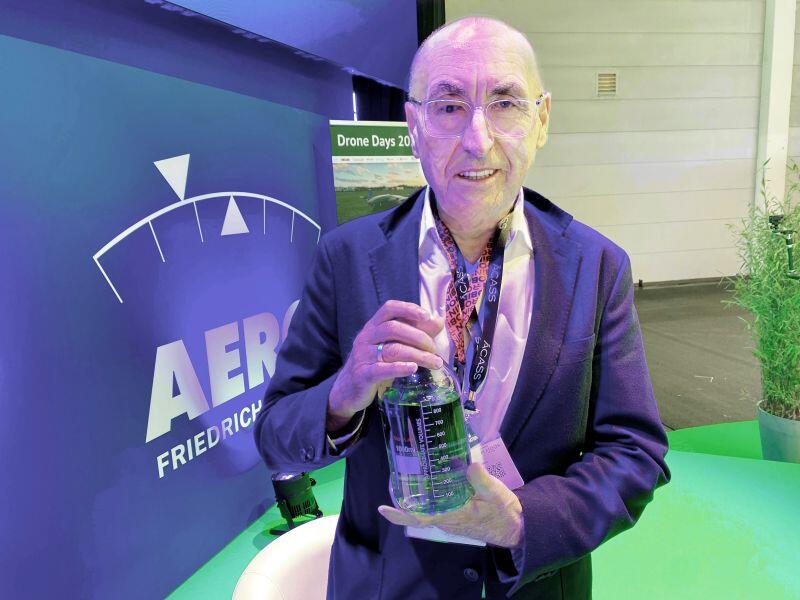 Bollinger Aviation founder Clemens Bollinger displays a bottle of green-dyed Swift 100R unleaded avgas. 
