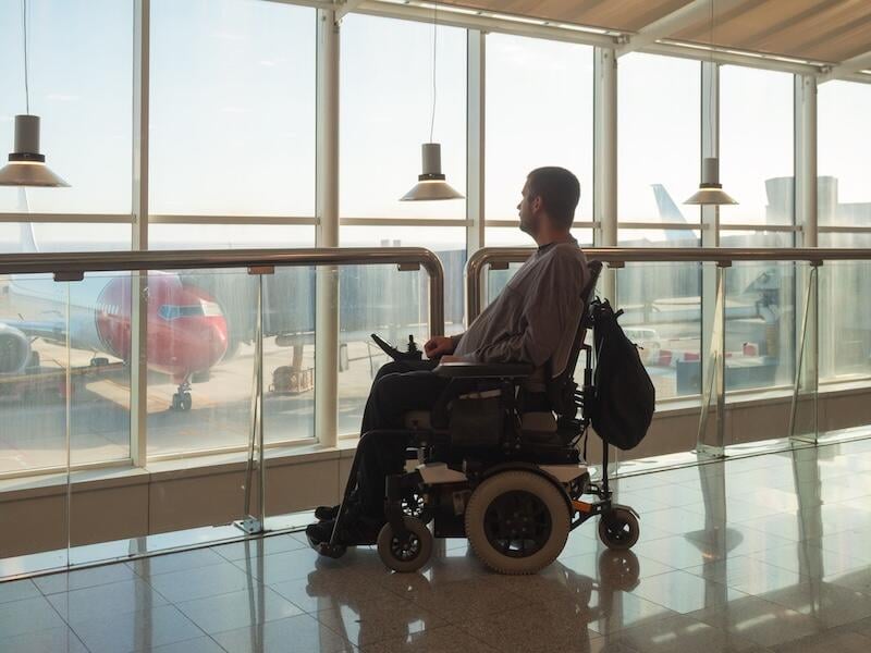 Motorized wheelchair user at airport