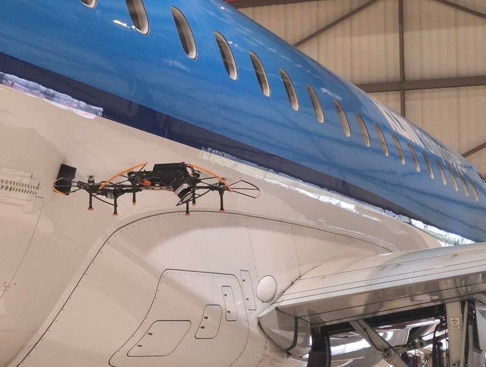 Drone inspecting aircraft
