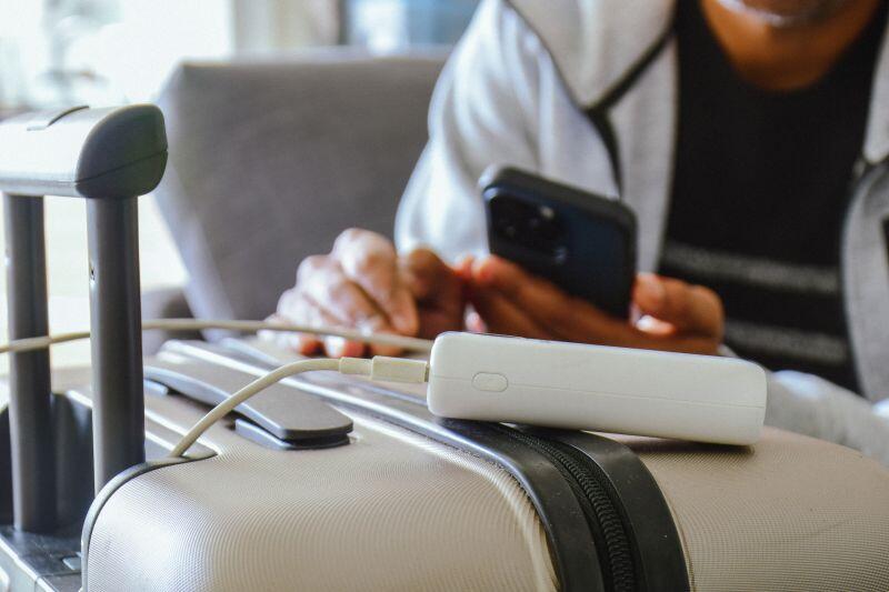 power bank charging cellphone on luggage