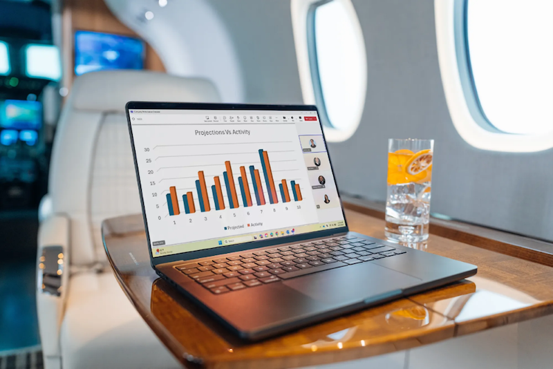 laptop and drink on a bizjet table
