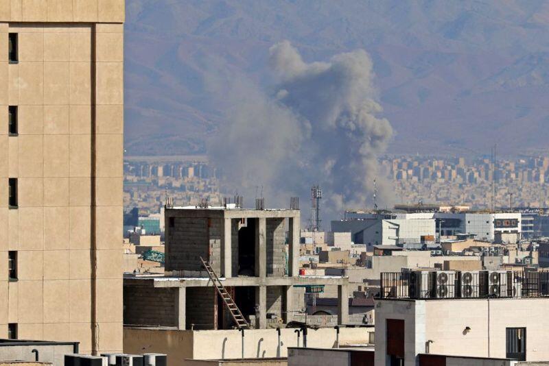 smoke plumes rising from buildings in the Middle East