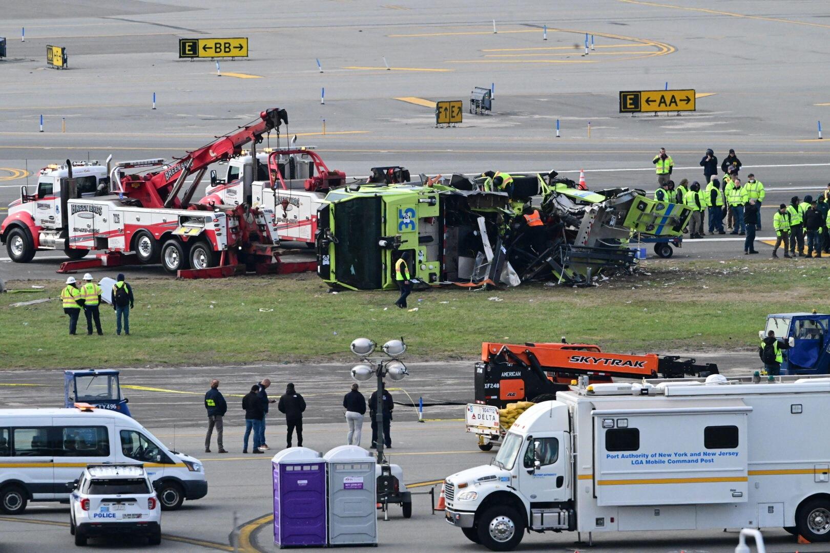 March 25, 2026, Queens, New York, Usa: (NEW) Airport maintenance crews position a tow truck as they prepare to move the wreckage of a Port Authority firetruck from the runway where it had collided with an Air Canada Express jet