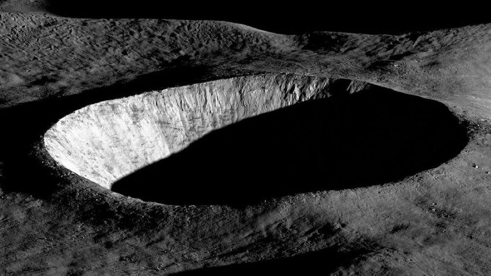 Early morning sunlight illuminates the western wall of this unnamed crater, leaving deep shadows on the ground and in the interior. The image was taken on August 30, 2023, by LROC (Lunar Reconnaissance Orbiter Camera). LROC is a system of three cameras and one of the seven instruments aboard NASA’s LRO (Lunar Reconnaissance Orbiter) mission, which launched in June 2009 and continues in orbit around the Moon. Credit: NASA/Arizona State University