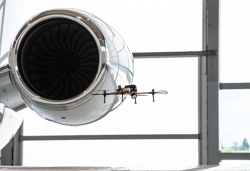 an engine with a drone flying next to it