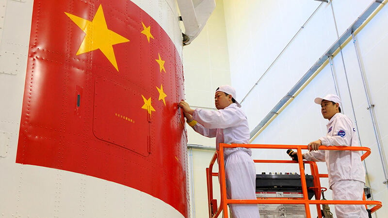 Chinese engineers check spacecraft fairing