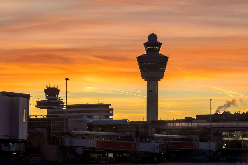 Schiphol Airport with a sunset in the background