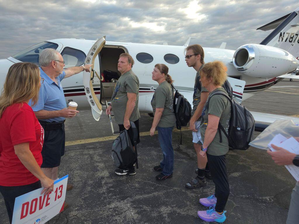 Jeff Greenberg greets players before flight