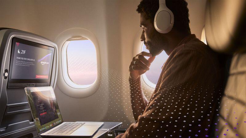 passenger listening to music and looking at computer 
