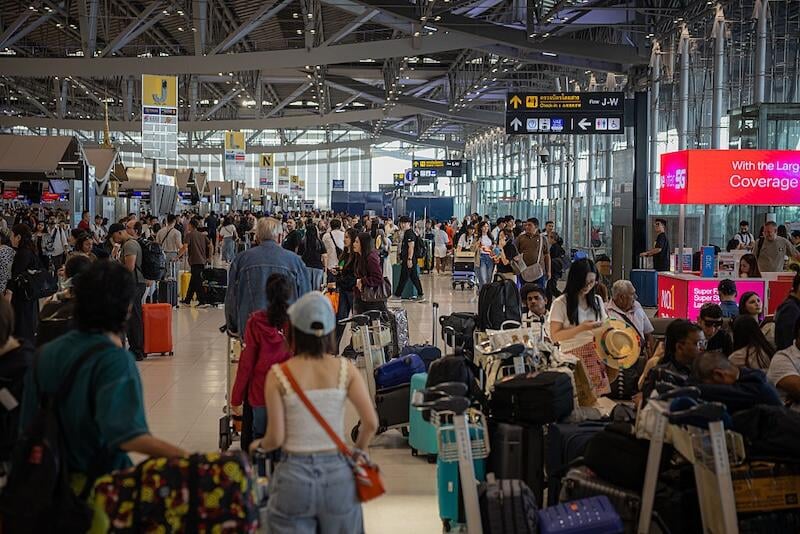 Passengers queue at airport
