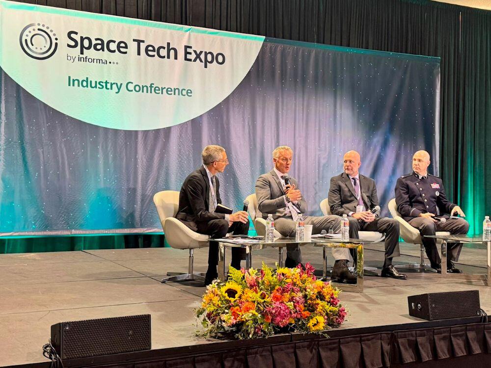 Aviation Week Defense & Space Executive Editor Robert Wall (left) moderates a space superiority panel with industry executives and Space Systems Command Deputy Commander Col. Andrew Menschner (right) at the 2026 Space Tech Expo on June 3, 2026, in Anaheim, California. Credit: Space Tech Expo // Informa 
