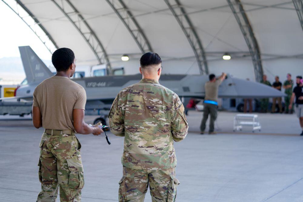 Airmen looking into a hangar