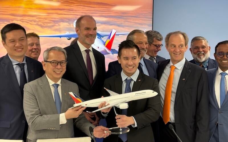 Philippine Airlines and Airbus officials unveil the A350-1000 commitment at the Farnborough Airshow.