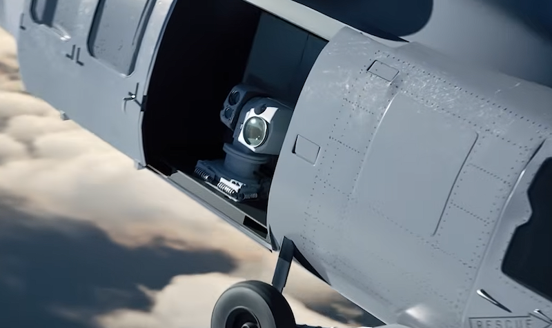 helicopter with an open side bay revealing a laser