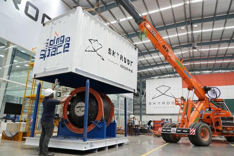 orange crane lifting aerospace container 