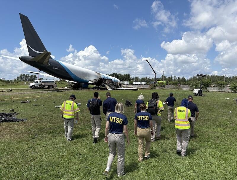 NTSB investigators approach a crashed 767F