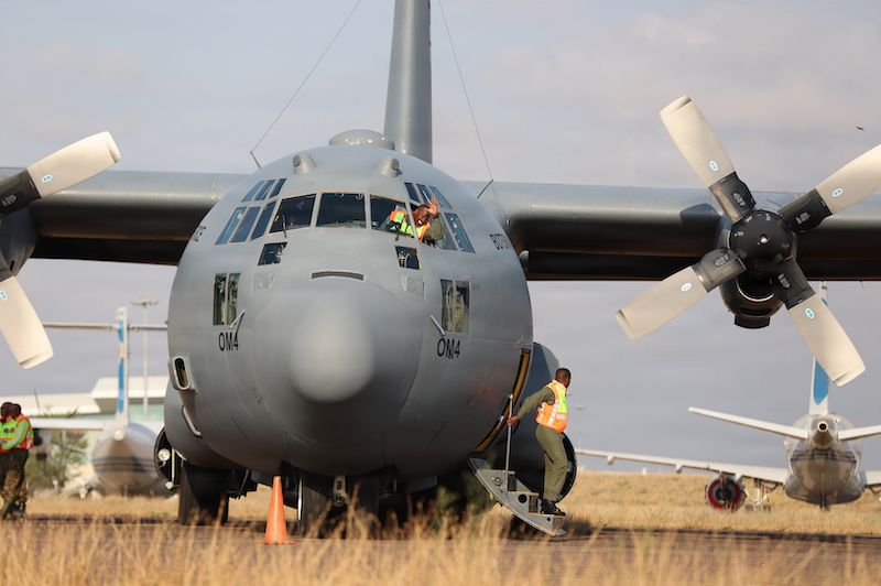 man waving from Lockheed C-130H in Botswana
