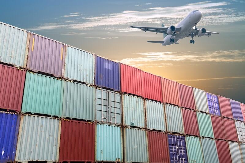 aircraft flying over containers