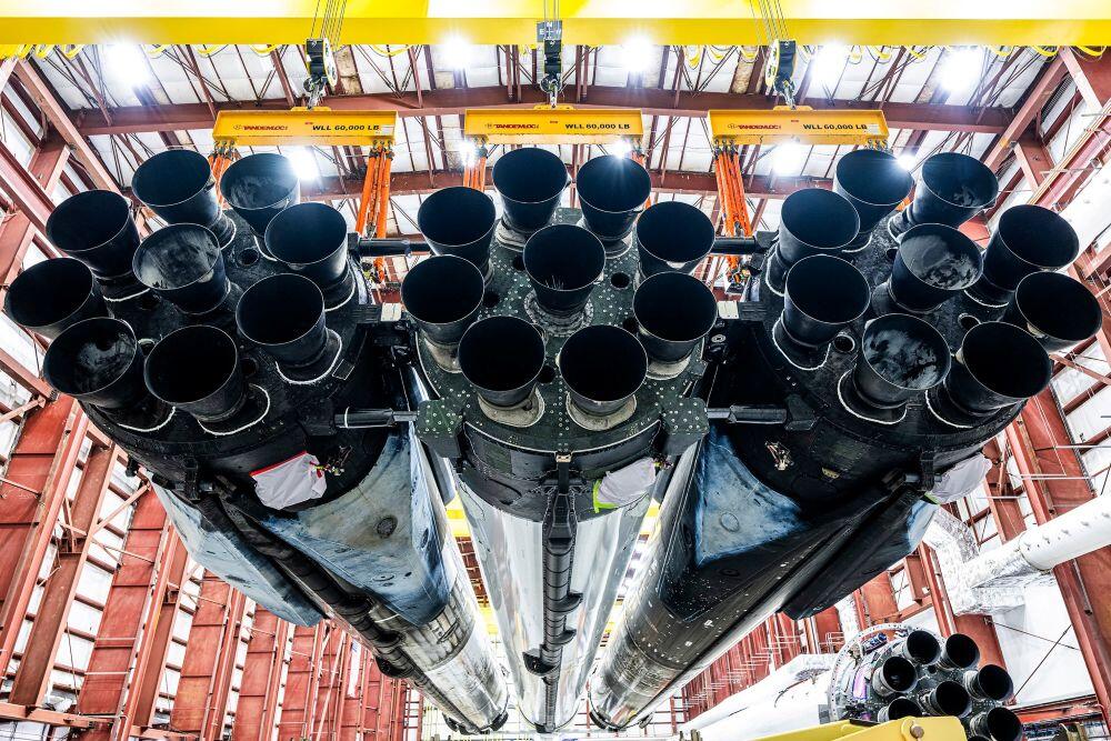 A SpaceX Falcon Heavy and its 27 Merlin engines are positioned in a hangar at Launch Complex 39A at the Kennedy Space Center in Florida, preparing to support the first National Reconnaissance Office mission using that launch vehicle. Credit: SpaceX