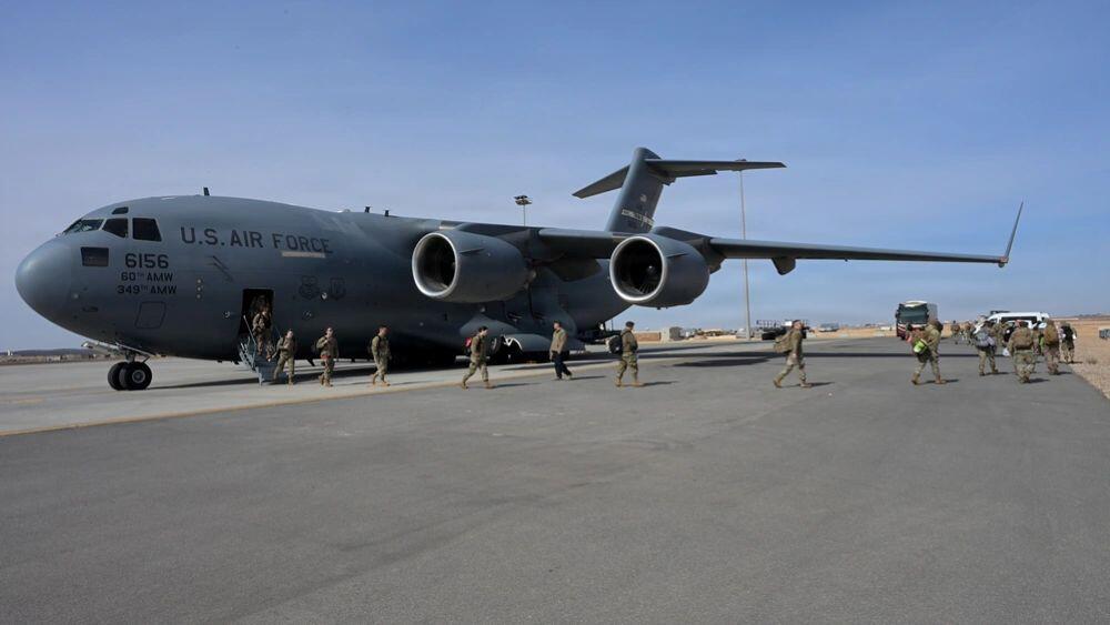 A U.S. Air Force C-17 and airmen arrive in the Middle East for a deployment in January.