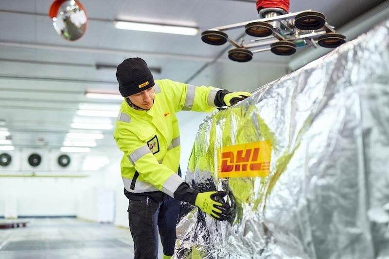 dhl worker securing shipment