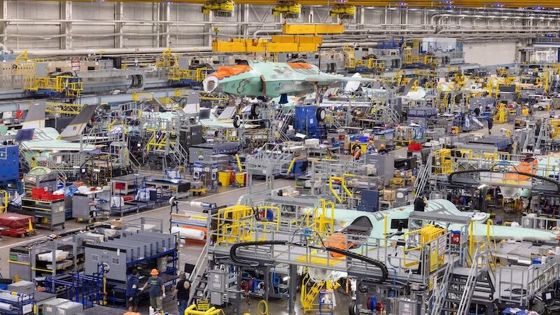 aircraft assembly factory with machinery and workers
