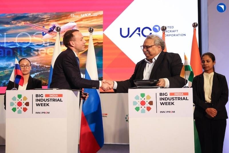 uac and pinnacle air officials shake hands at big india industrial week