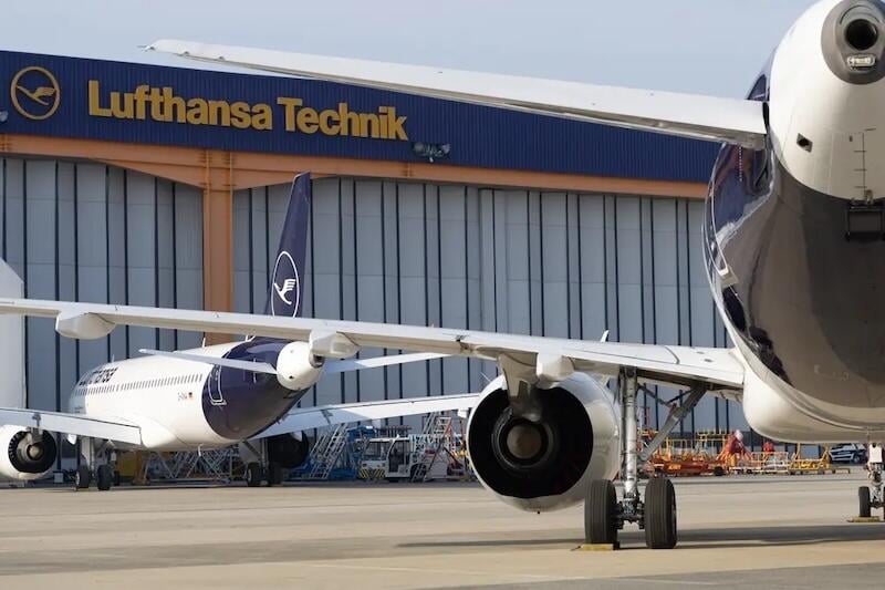 commercial lufthansa aircraft parked outside lufthansa technik hangar