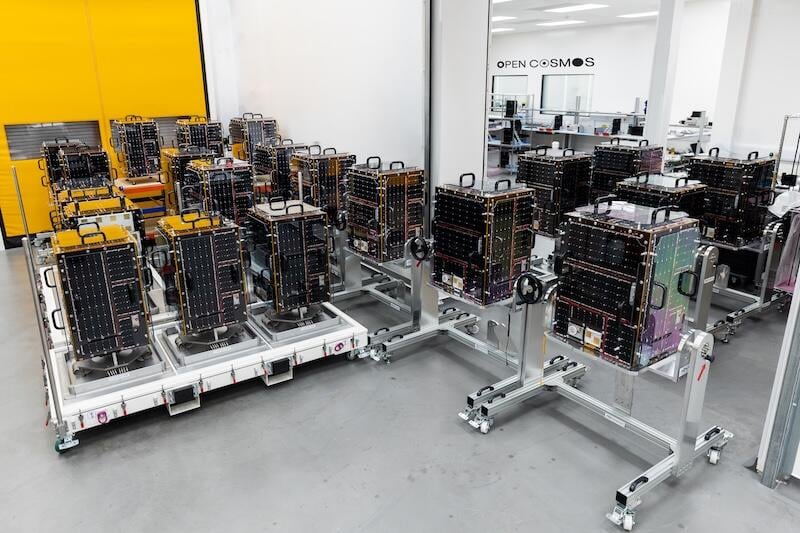 rows of satellite components on wheeled stands