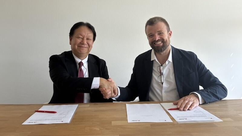 mitsubishi and swissto12 executives shake hands