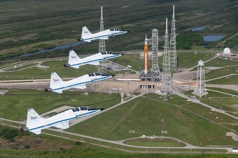 nasa t-38s fly over space launch system