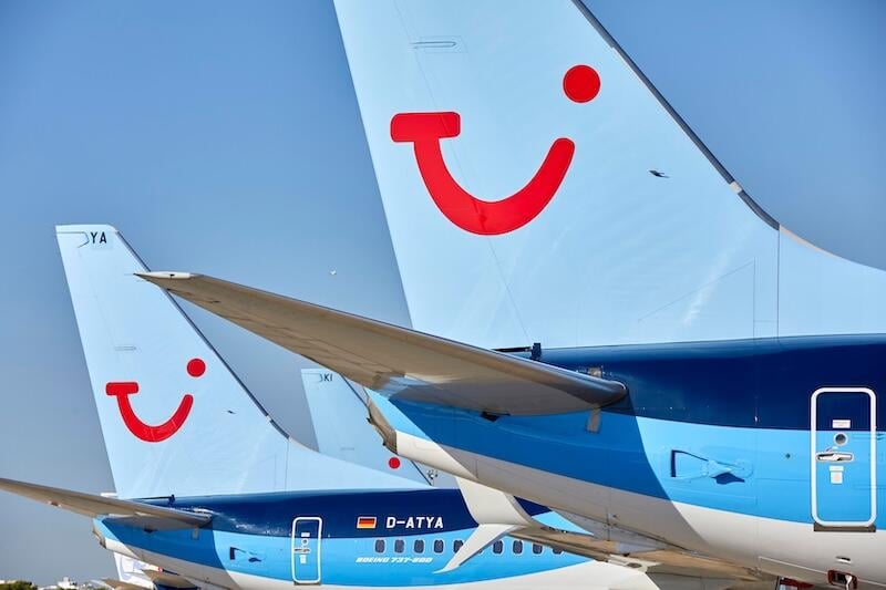 close-up of several tui aircraft sit on airport tarmac