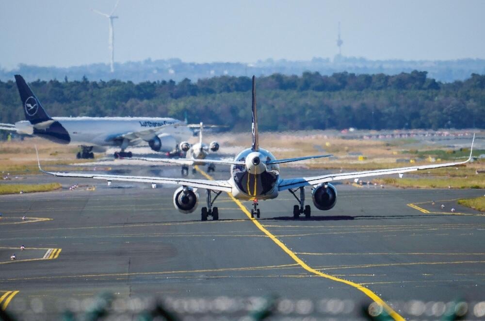 Passenger planes taxi to the runway at the Rhine-Main Airport.