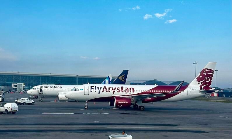 air astana and FlyArystan aircraft on an airport tarmac