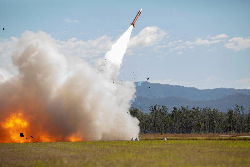 missile launches from grassy field